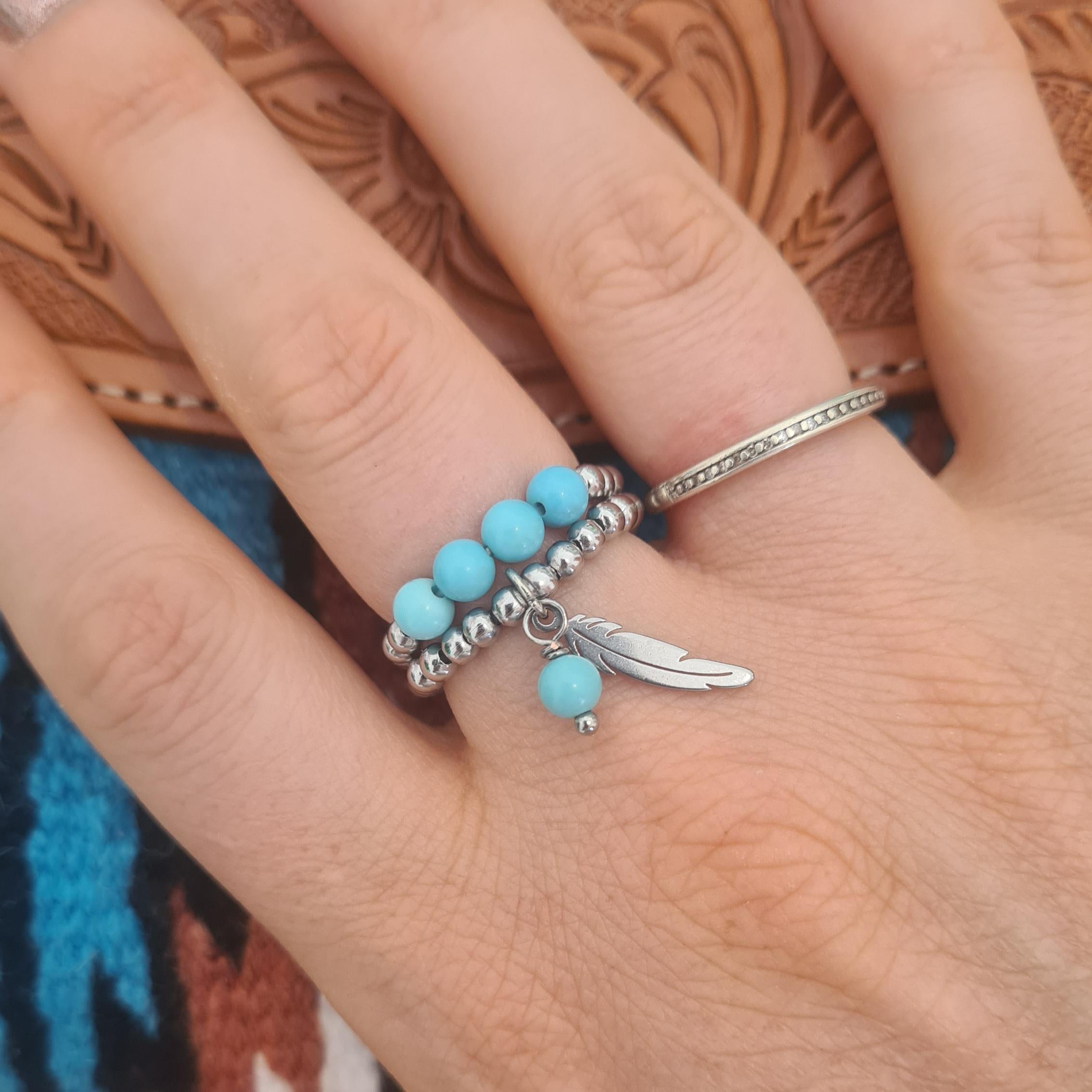 Fly free stainless steel beaded ring with genuine turquoise and stainless steel feather charms.