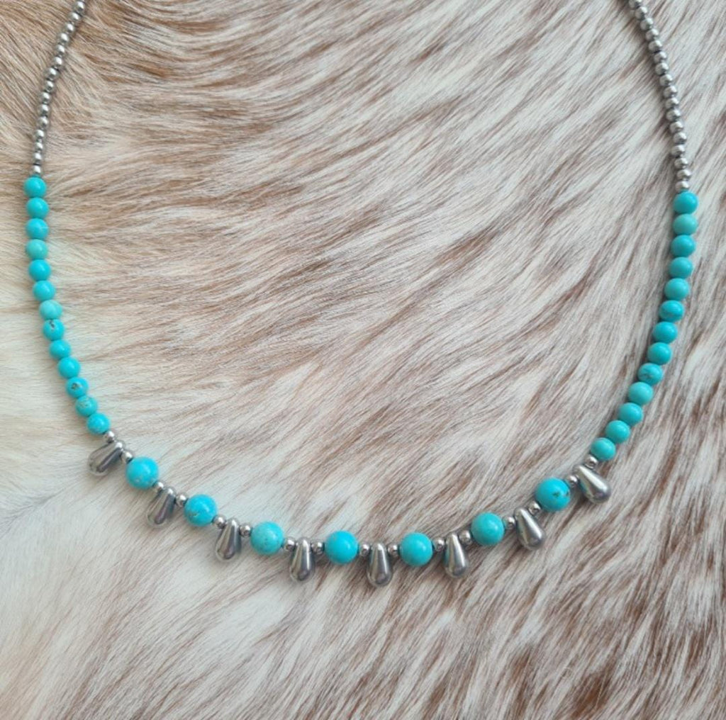 Even Cowgirls Get the Blues genuine turquoise and stainless steel teardrop beaded necklace.