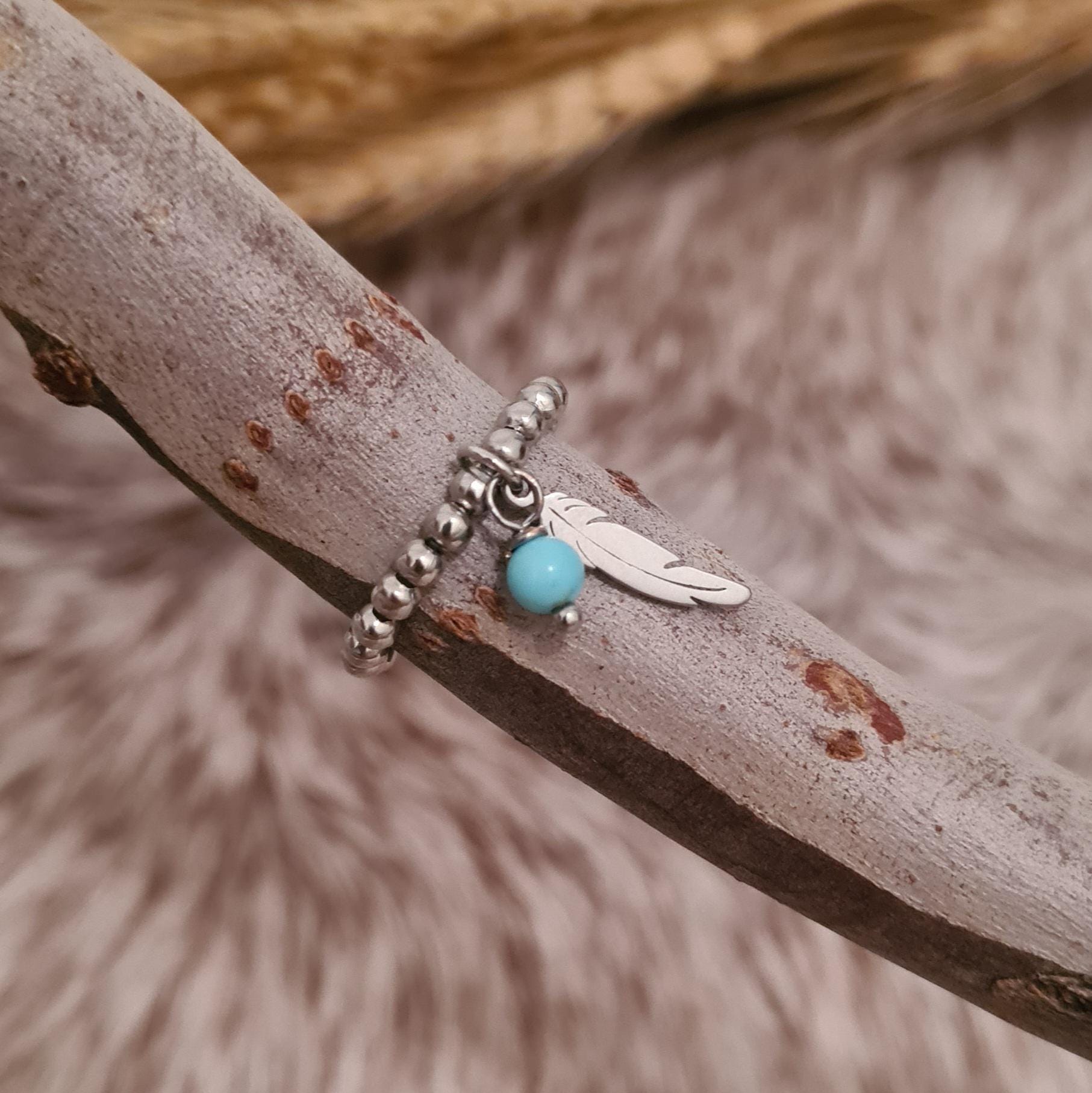 Fly free stainless steel beaded ring with genuine turquoise and stainless steel feather charms.