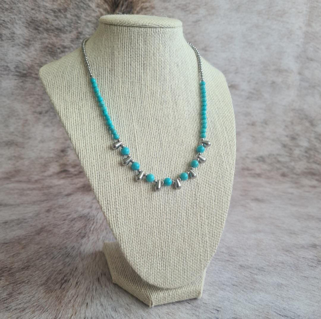 Even Cowgirls Get the Blues genuine turquoise and stainless steel teardrop beaded necklace.