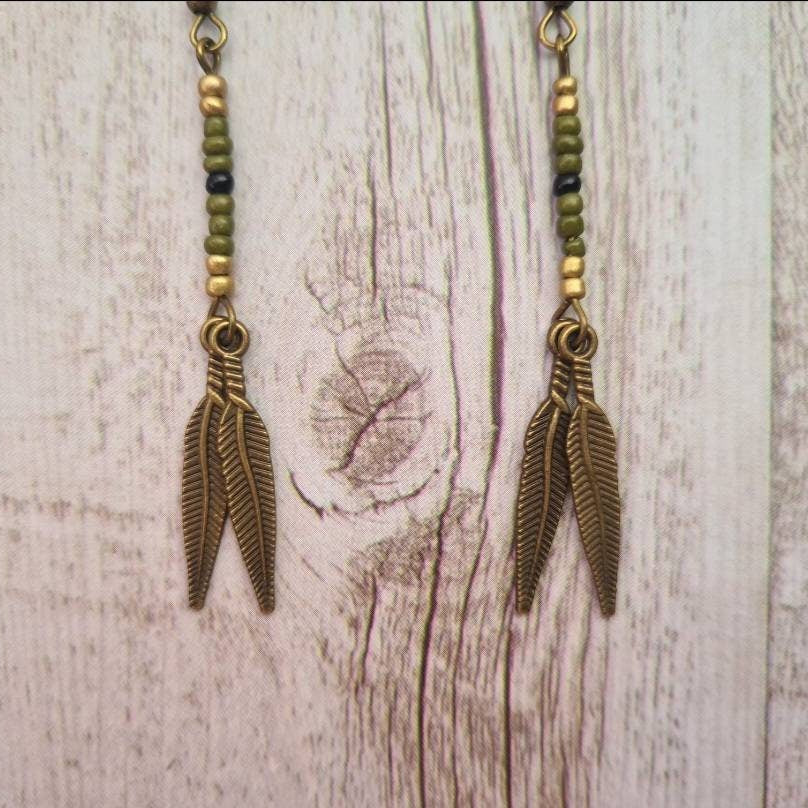 American West beaded feather drop earrings.