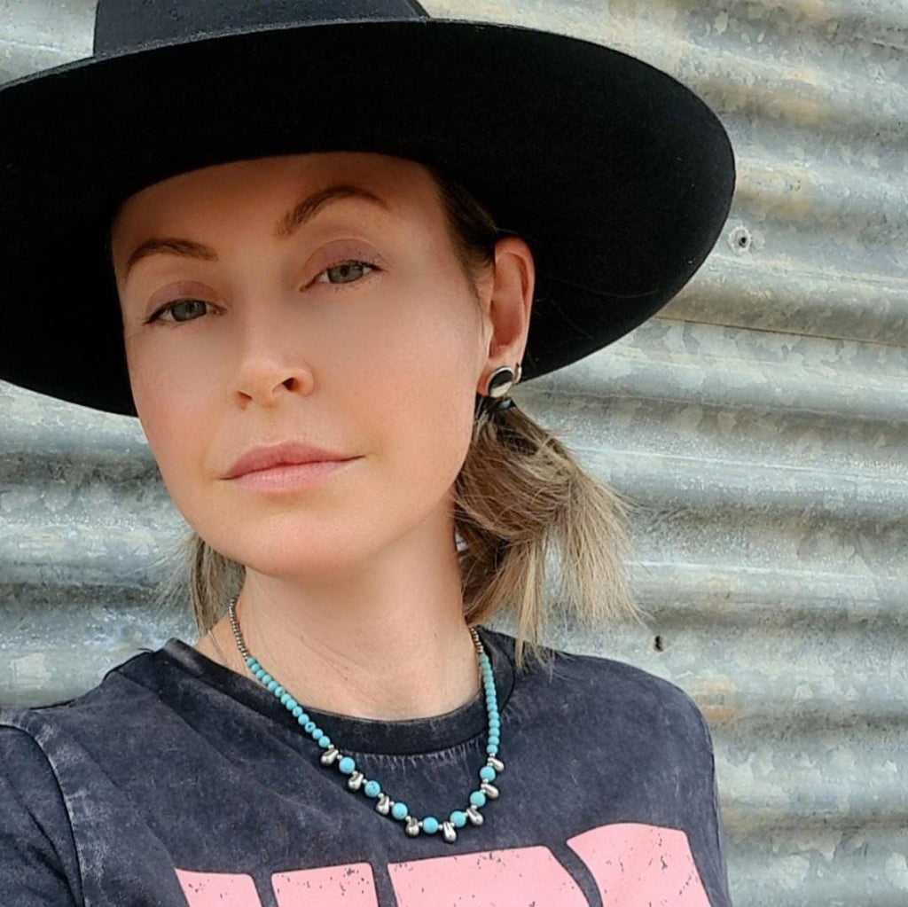 Even Cowgirls Get the Blues genuine turquoise and stainless steel teardrop beaded necklace.