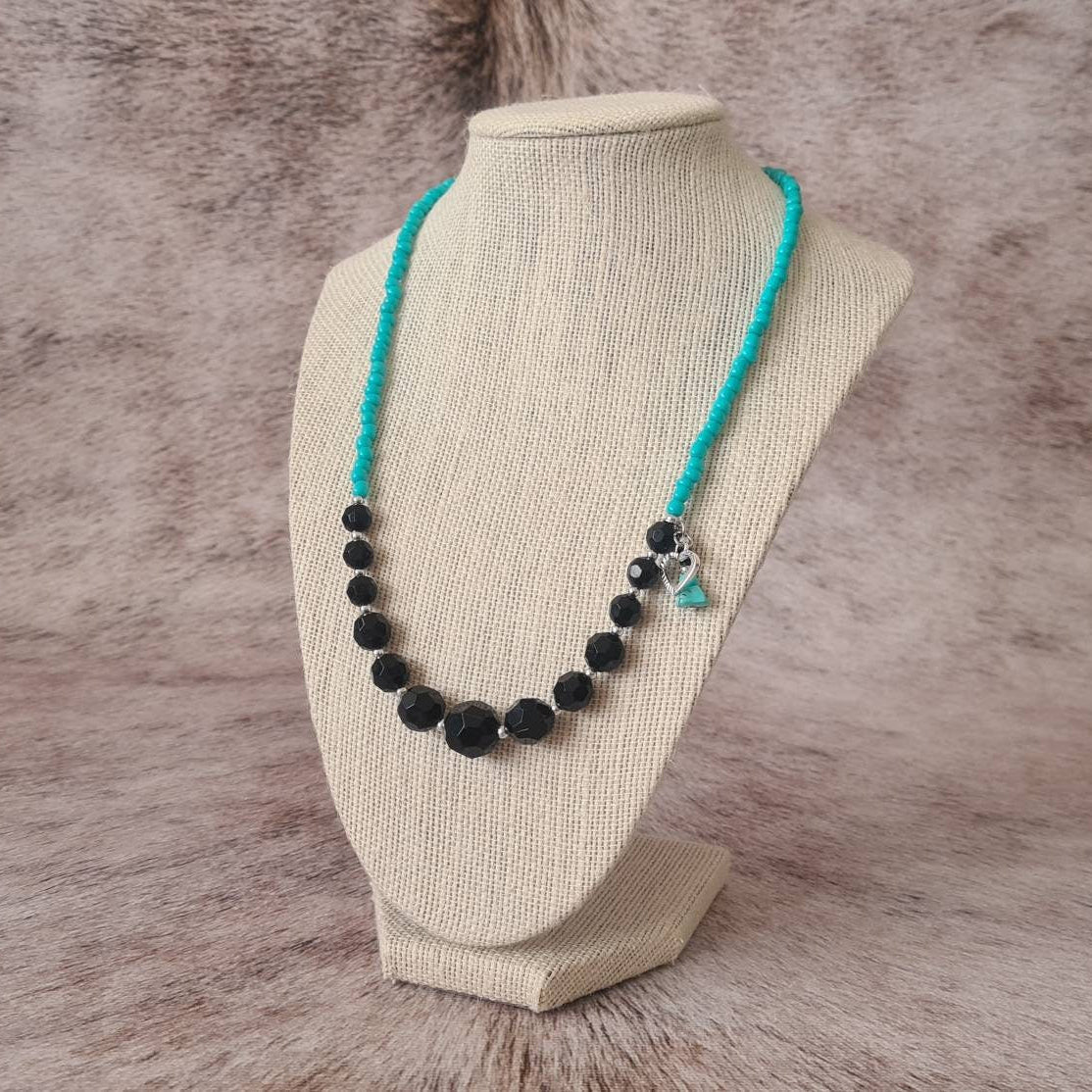 Cross My Heart beaded necklace with turquoise chip and heart charm.