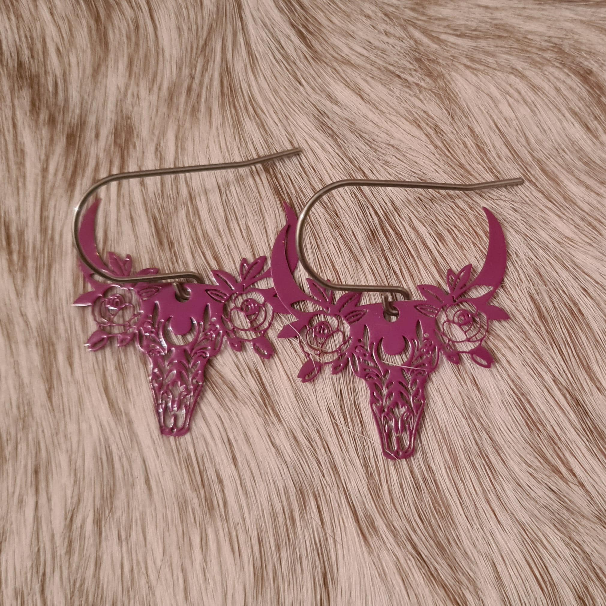 Little Miss floral filigree steer skull earrings.