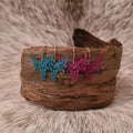 Little Miss floral filigree steer skull earrings.