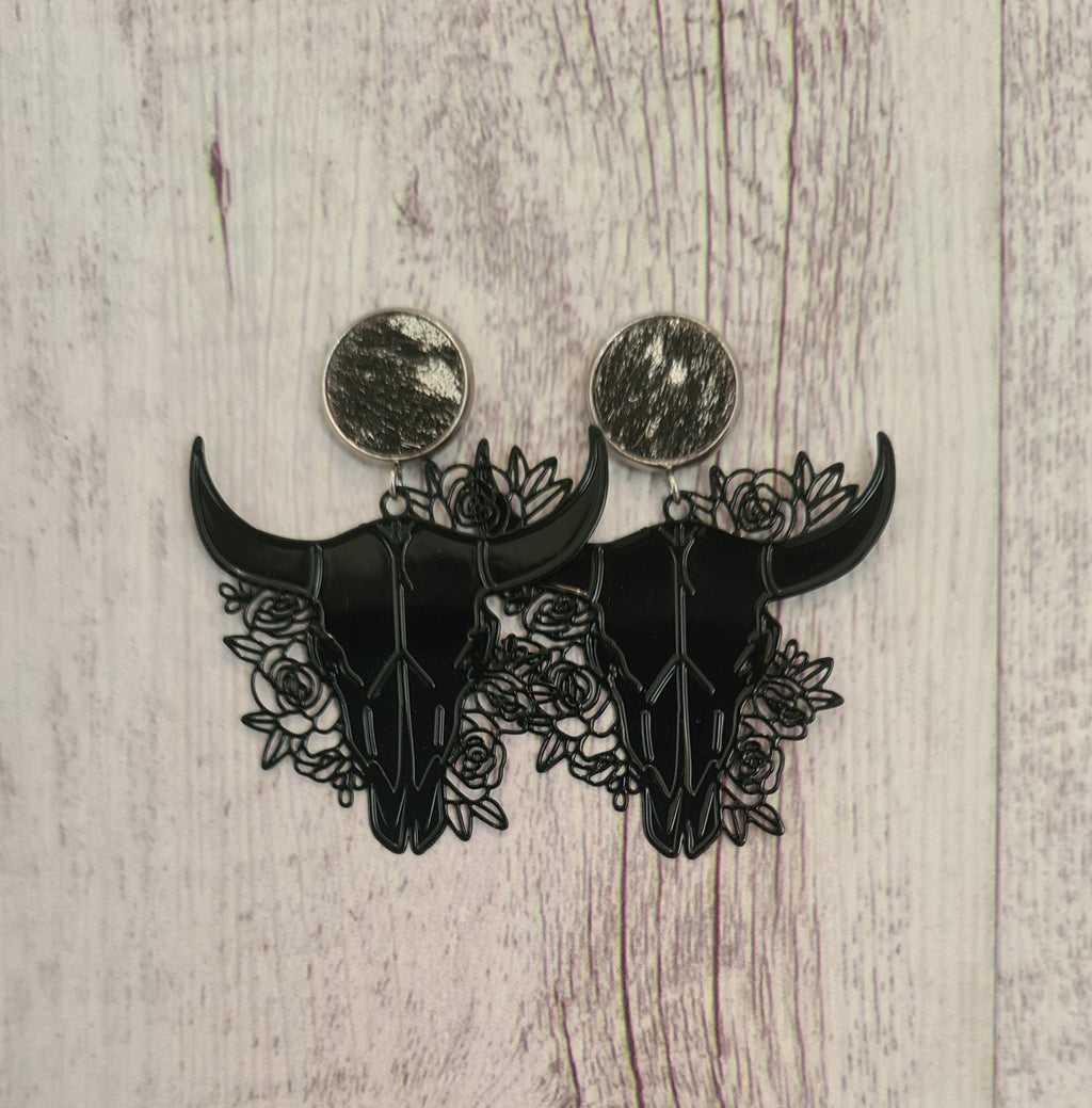 Rodeo Nights genuine cowhide studs with floral filigree steer skulls.