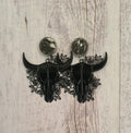 Rodeo Nights genuine cowhide studs with floral filigree steer skulls.