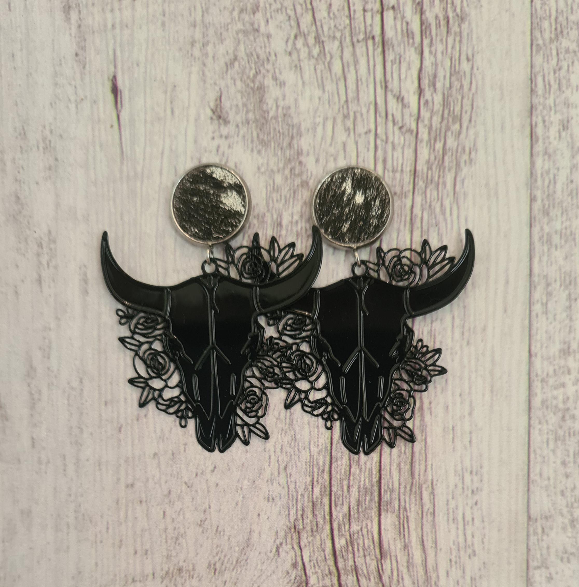 Rodeo Nights genuine cowhide studs with floral filigree steer skulls.