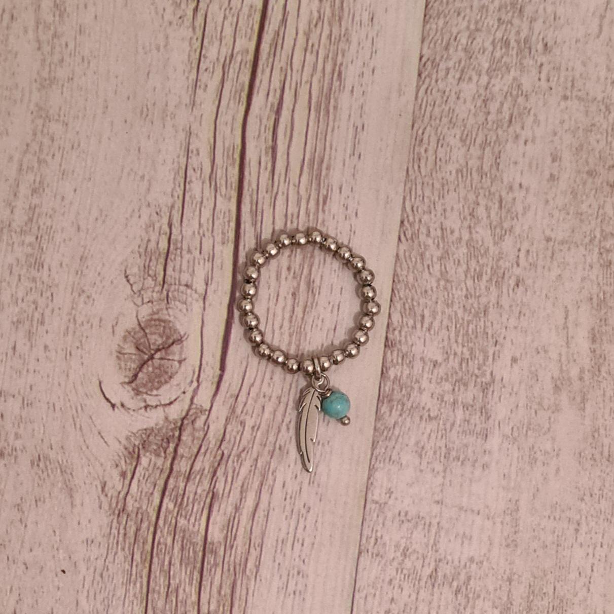 Fly free stainless steel beaded ring with genuine turquoise and stainless steel feather charms.